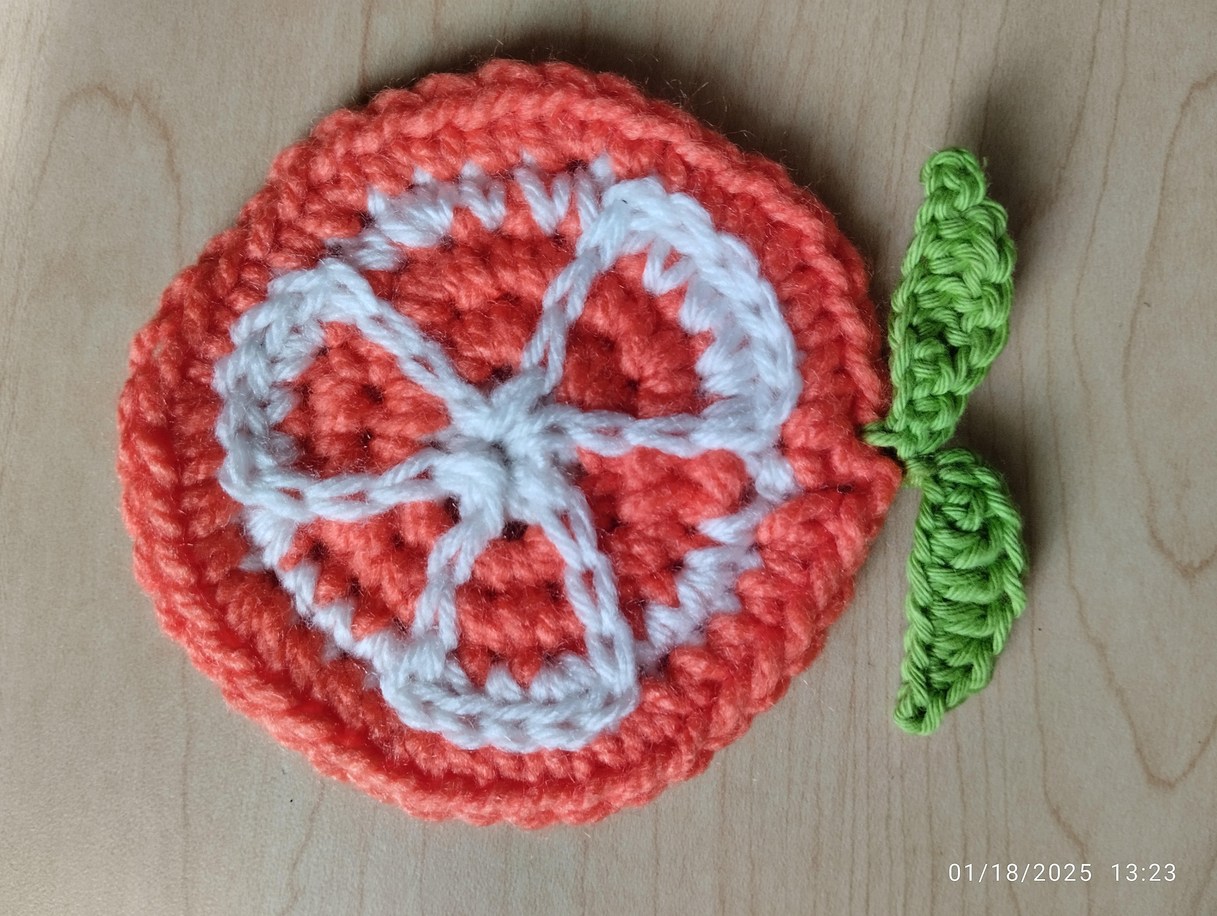 crochet orange slice with two leaves